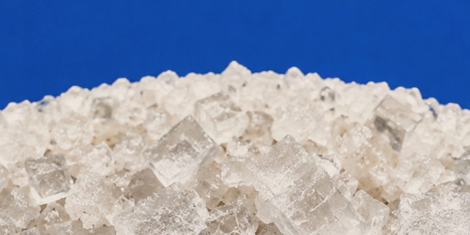 Cubic sea salt crystals against cobalt blue