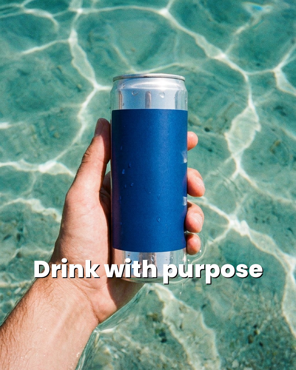 A hand holding a MORPHO can in clear blue water, with the words Drink with purpose